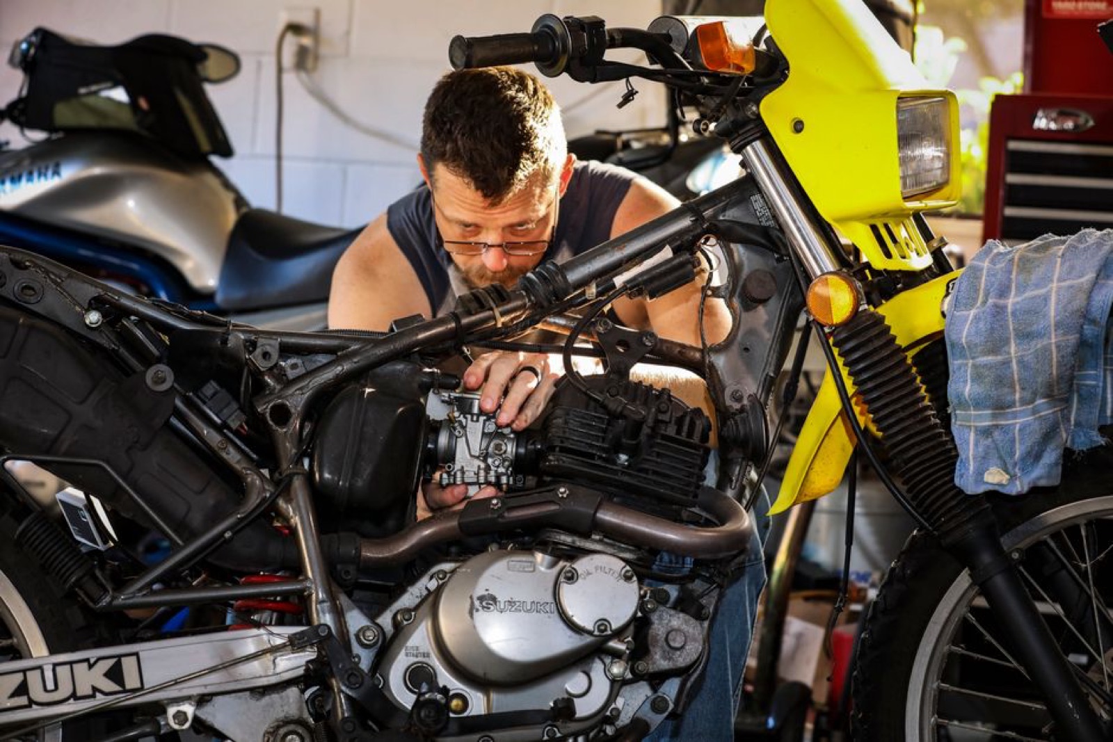 Mechanic inspecting a motorcycle for a recall repair in a Chicago shop
